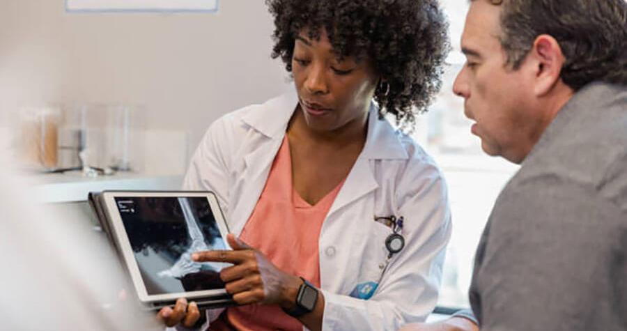 Physician reviewing x-ray with patient